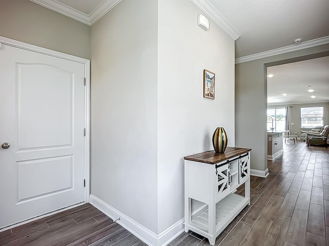 hall with dark wood-type flooring, baseboards, crown molding, and recessed lighting