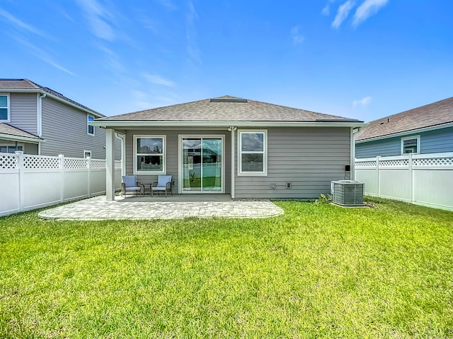 back of property with central air condition unit, a patio area, and a shingled roof