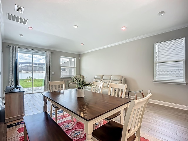dining area with crown molding, baseboards, recessed lighting, and wood finished floors