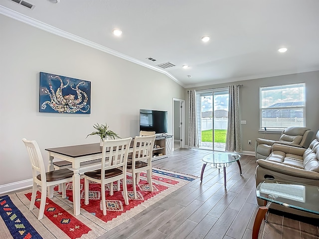 dining room featuring ornamental molding, baseboards, wood finished floors, and recessed lighting