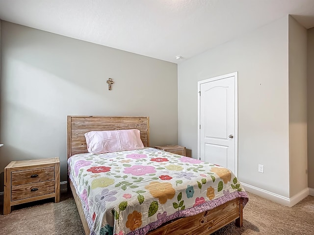 bedroom featuring carpet floors and baseboards
