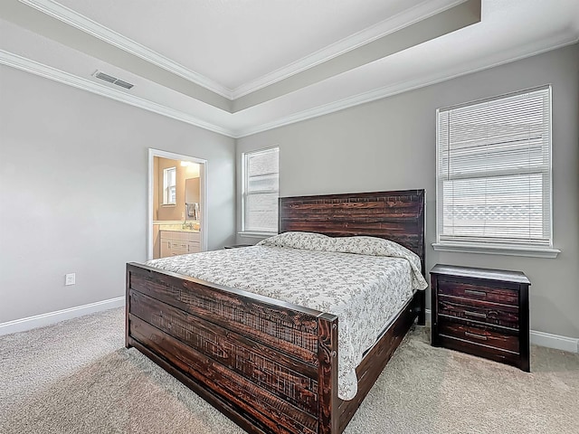 bedroom featuring carpet, baseboards, crown molding, and ensuite bath