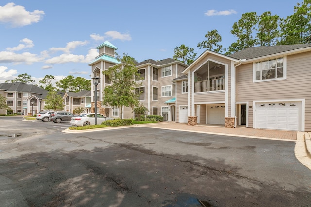 exterior space featuring a garage and a balcony