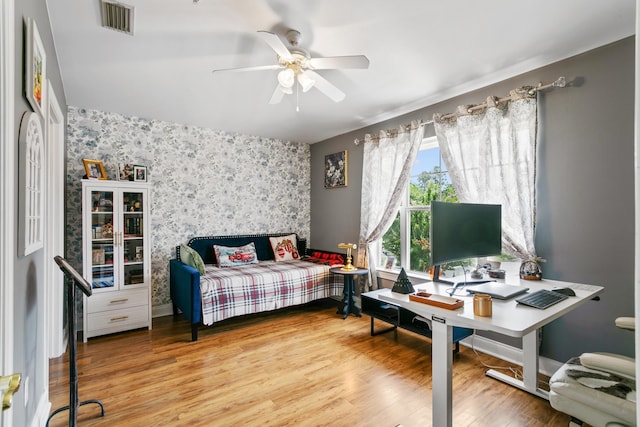 bedroom with ceiling fan, hardwood / wood-style floors, and fridge