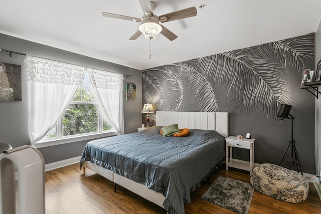 bedroom featuring hardwood / wood-style floors and ceiling fan