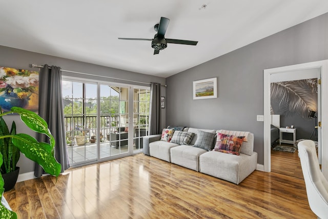 living room featuring ceiling fan, wood-type flooring, and vaulted ceiling