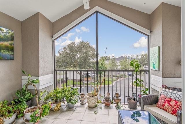 sunroom featuring ceiling fan, a wealth of natural light, and vaulted ceiling