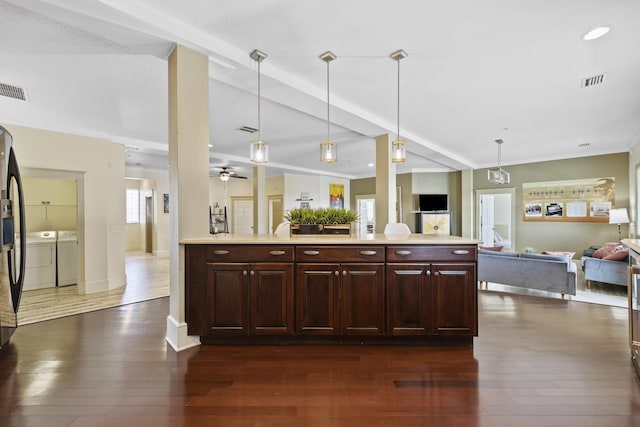 kitchen featuring pendant lighting, separate washer and dryer, ceiling fan, and dark wood-type flooring