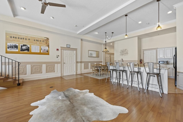 living room with light hardwood / wood-style flooring and a textured ceiling