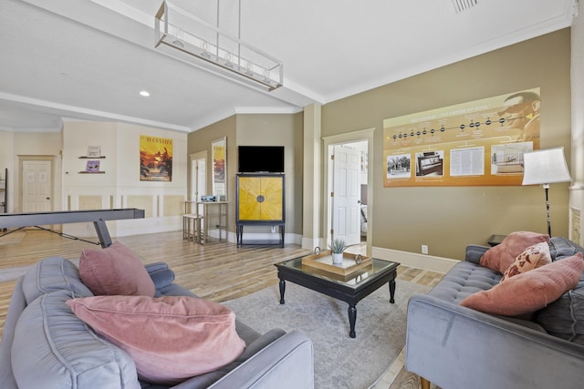 living room with light hardwood / wood-style flooring and crown molding