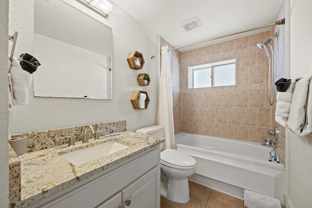 full bathroom with tile patterned floors, a textured ceiling, vanity, shower / tub combo with curtain, and toilet