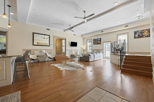 living room featuring dark hardwood / wood-style flooring, plenty of natural light, and a textured ceiling