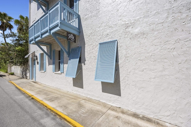 view of side of home with a balcony