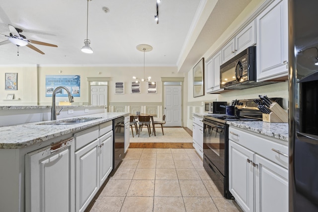 kitchen with pendant lighting, black appliances, ceiling fan with notable chandelier, crown molding, and sink