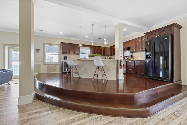 interior space featuring wine cooler, crown molding, and light wood-type flooring