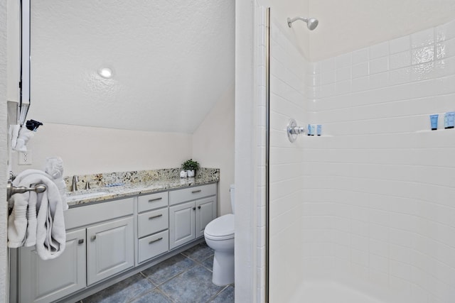 bathroom featuring a shower, tile patterned flooring, vanity, and toilet