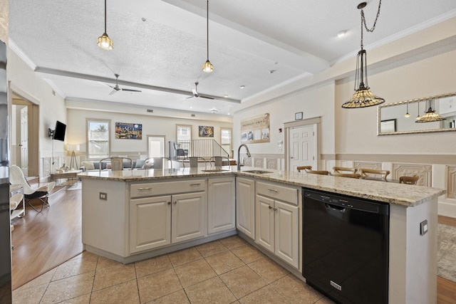 kitchen with dishwasher, a textured ceiling, hanging light fixtures, and light hardwood / wood-style flooring