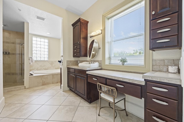 bathroom featuring tile patterned floors, vanity, and plus walk in shower