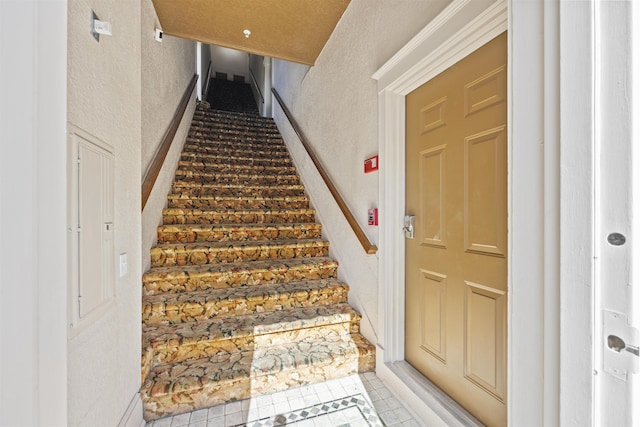 staircase with tile patterned flooring