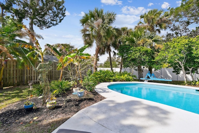 deck featuring a swimming pool and an outdoor living space with a fire pit