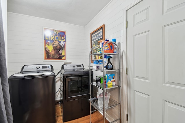 laundry room featuring hardwood / wood-style flooring and washer and dryer
