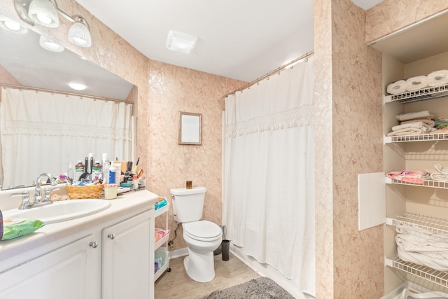 bathroom with hardwood / wood-style flooring, vanity, curtained shower, and toilet