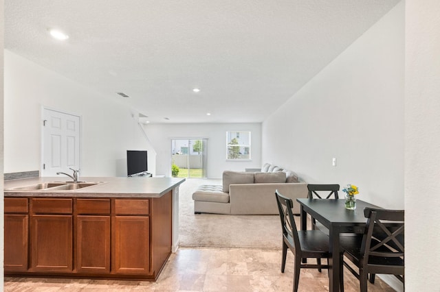 69 Mustard Hill Ct, Saint Augustine, FL 32086 - kitchen featuring a sink, brown cabinets, open floor plan, a peninsula, and light countertops