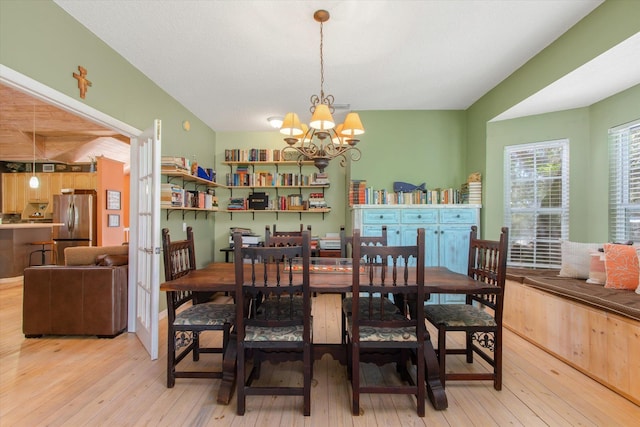 1440 Corunna St, Saint Augustine, FL 32080 - dining space with light wood-style floors and a chandelier