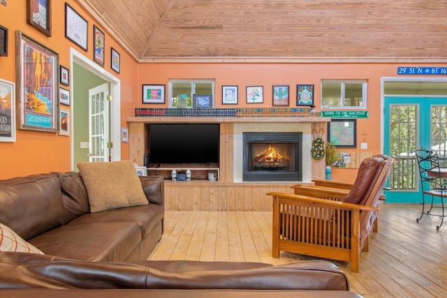 1440 Corunna St, Saint Augustine, FL 32080 - living area with hardwood / wood-style floors, wooden ceiling, vaulted ceiling, and a tile fireplace