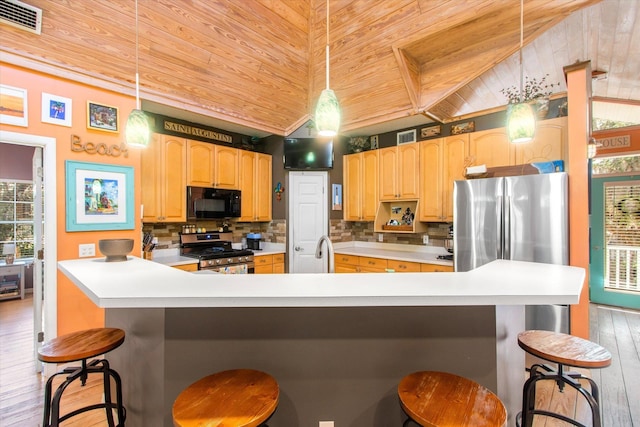 1440 Corunna St, Saint Augustine, FL 32080 - kitchen featuring tasteful backsplash, visible vents, wood ceiling, light wood-type flooring, and appliances with stainless steel finishes