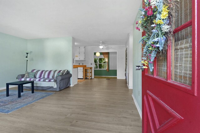 entryway with baseboards, wood finished floors, and a ceiling fan