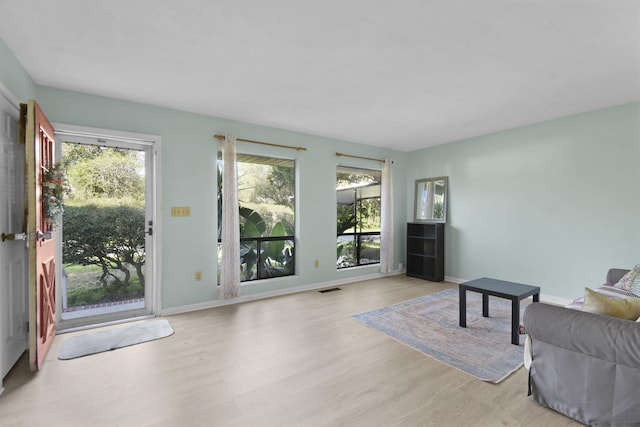 living room featuring light wood-type flooring and baseboards