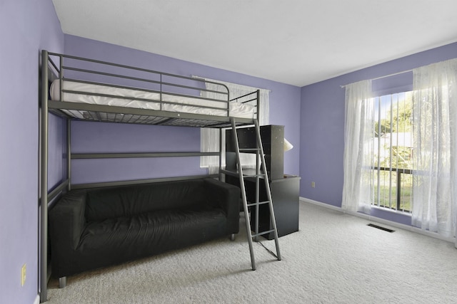 bedroom featuring carpet and baseboards