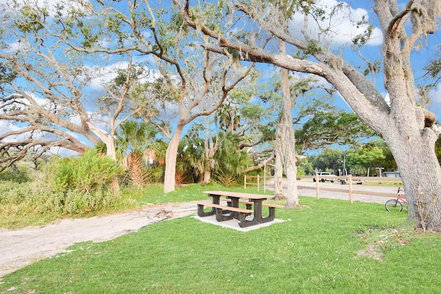 view of property's community with a lawn