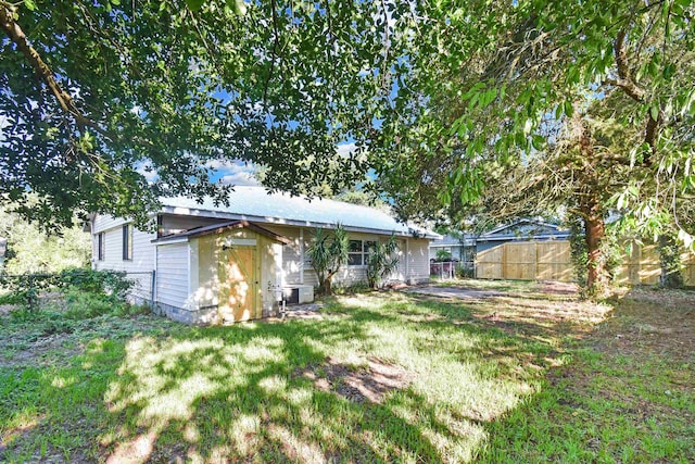 rear view of property featuring metal roof
