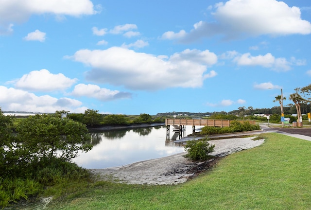 dock area featuring a water view and a yard
