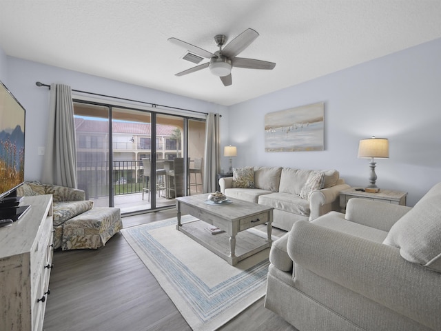 living room featuring hardwood / wood-style floors and ceiling fan