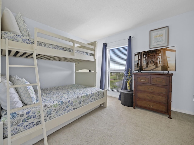 carpeted bedroom featuring a textured ceiling