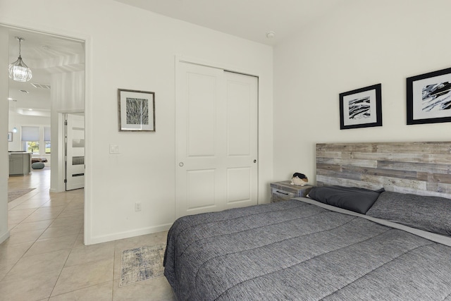 bedroom featuring a closet and light tile patterned floors