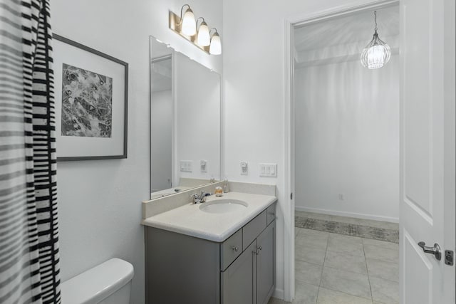 bathroom with tile patterned floors, vanity, and toilet