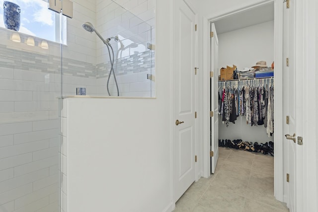 bathroom featuring a tile shower and tile patterned floors