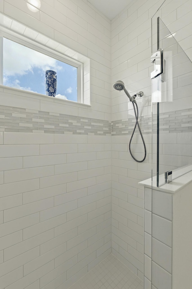 bathroom with a tile shower