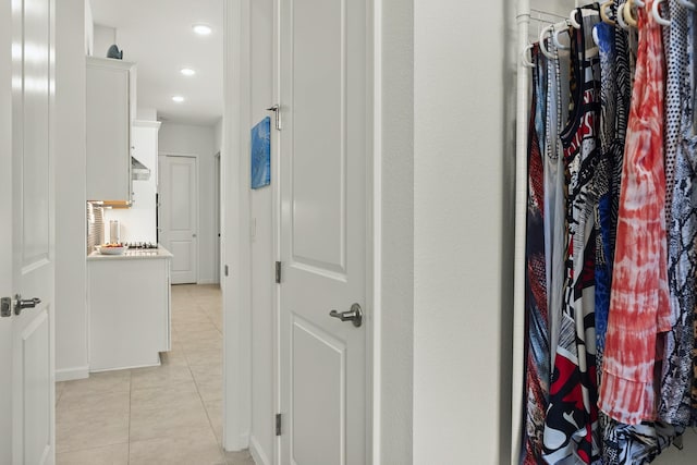 hall featuring light tile patterned floors