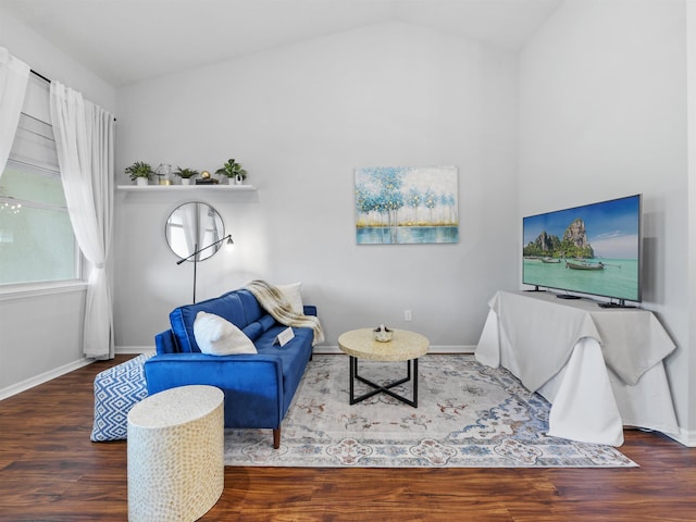 living room featuring vaulted ceiling and dark wood-type flooring