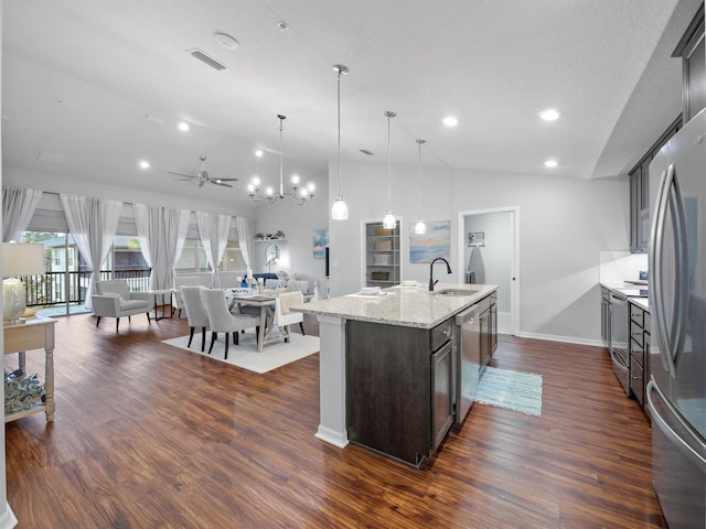 kitchen featuring a kitchen island with sink, pendant lighting, sink, dark brown cabinets, and ceiling fan with notable chandelier