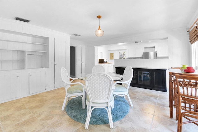 dining room with built in features and a healthy amount of sunlight