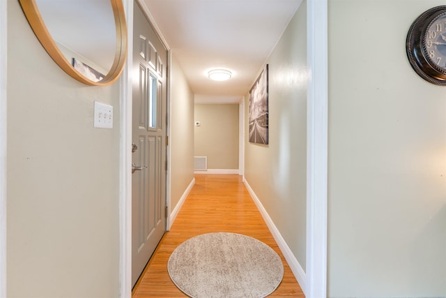 hallway with light hardwood / wood-style flooring