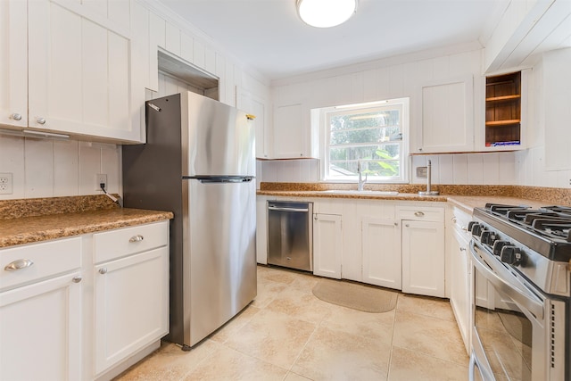 kitchen featuring sink, white cabinetry, ornamental molding, and stainless steel appliances