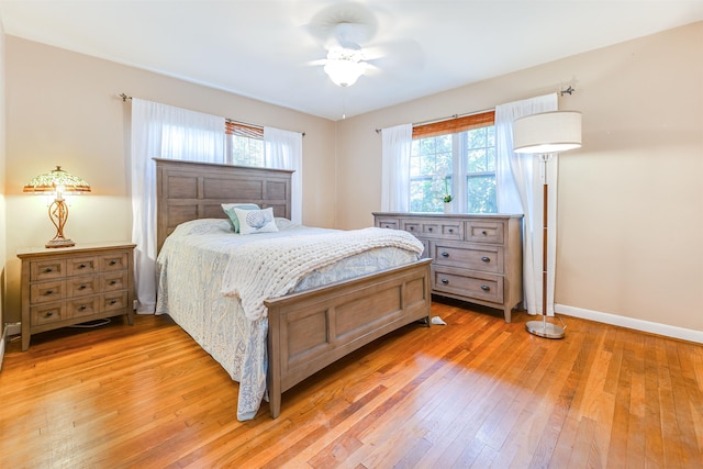 bedroom with ceiling fan and wood-type flooring