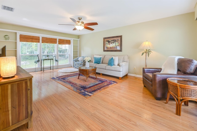 living room with ceiling fan and light wood-type flooring